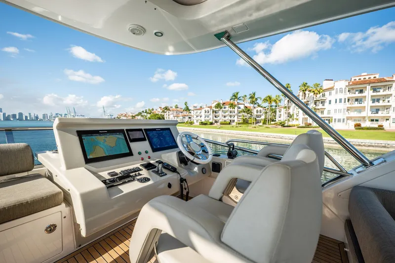 Amici Yacht Photos Pics Luxurious 2017 Azimut 66 yacht helm with scenic waterfront view.