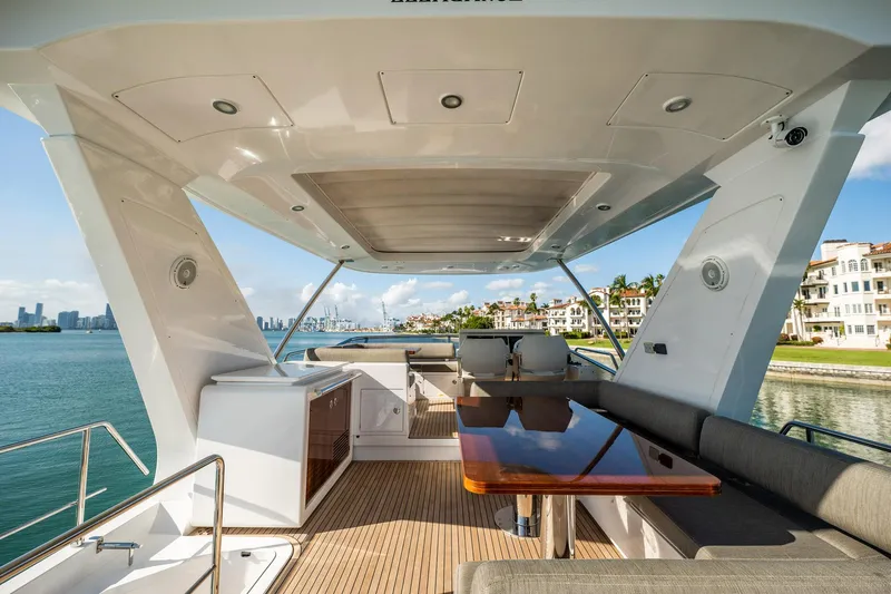 Amici Yacht Photos Pics Luxurious 2017 Azimut 66 yacht deck with seating, table, and ocean view.