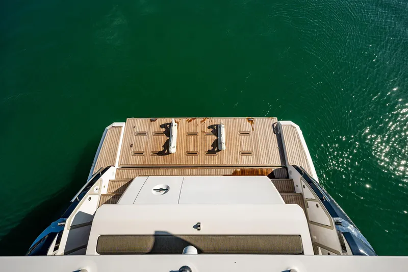 Amici Yacht Photos Pics 2017 Azimut 66 yacht stern view with teak swim platform on calm water.