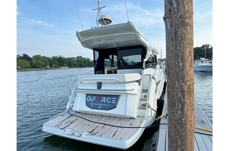  Yacht Photos Pics 2024 Galeon 425 HTS yacht docked at marina, rear view with water and trees.