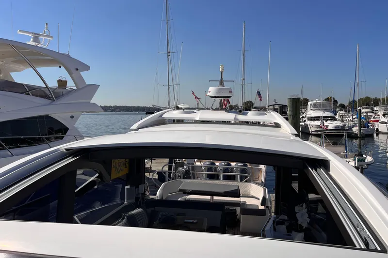  Yacht Photos Pics 2024 Galeon 425 HTS yacht docked at marina, surrounded by other boats under clear blue sky.
