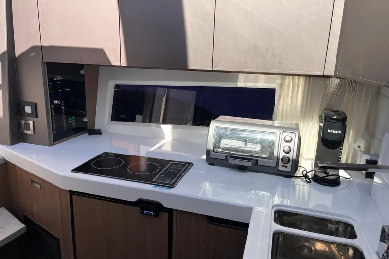  Yacht Photos Pics Modern kitchen interior of 2024 Galeon 425 HTS yacht with appliances and sleek design.