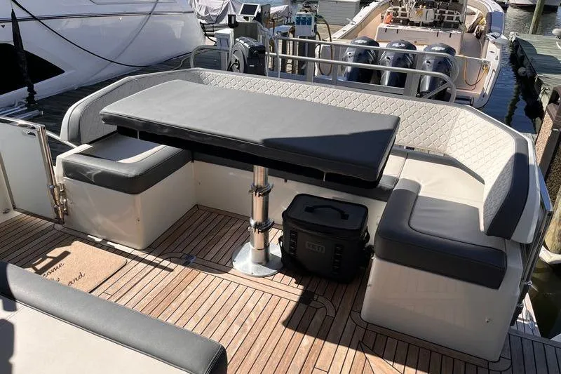  Yacht Photos Pics 2024 Galeon 425 HTS yacht deck with seating and table, docked at marina.