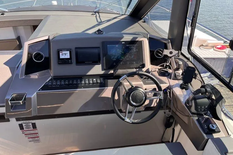  Yacht Photos Pics 2024 Galeon 425 HTS yacht helm with modern navigation controls and steering wheel.