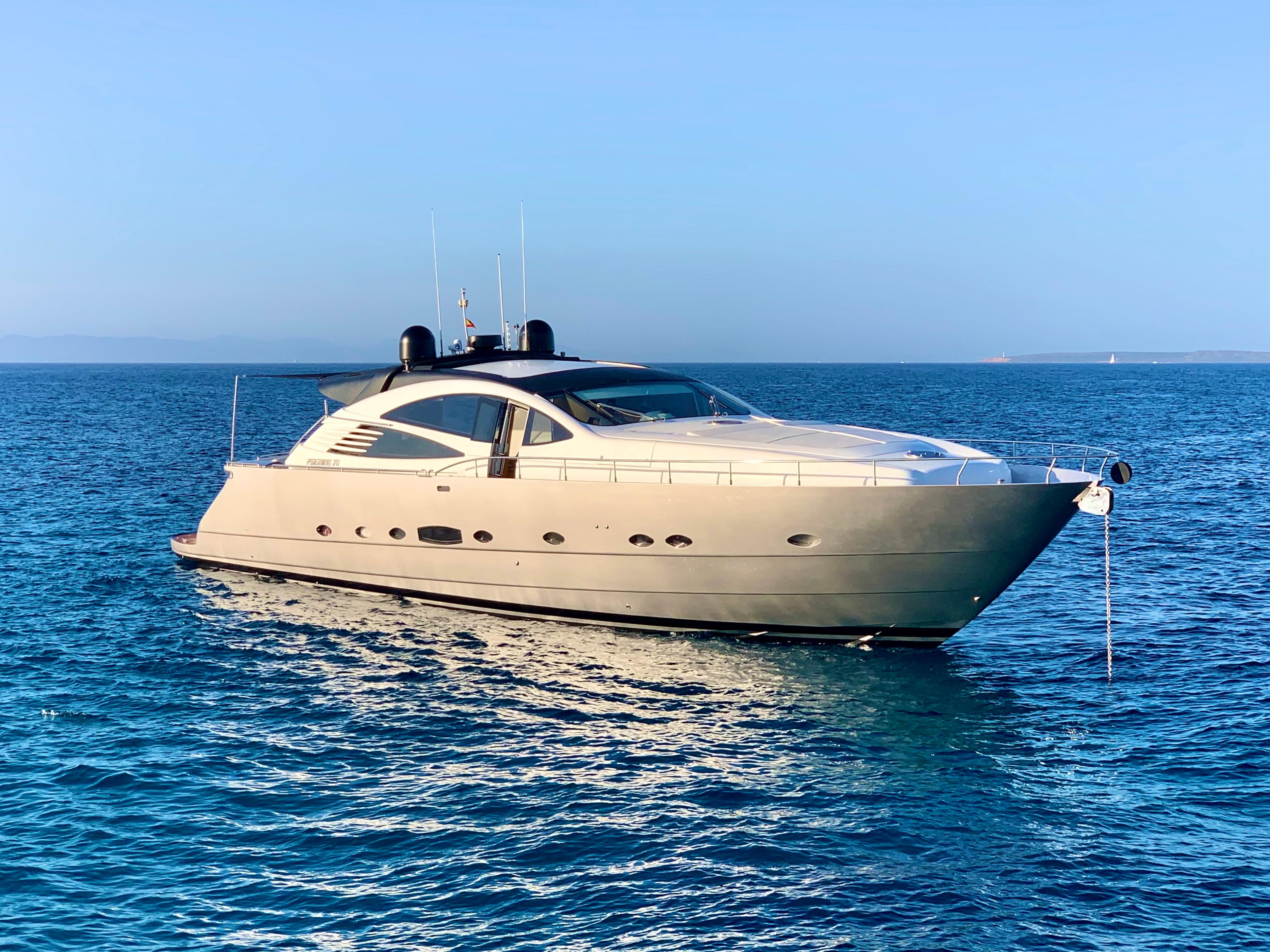 Luxury 2005 Pershing 76 yacht on calm blue sea under clear sky.