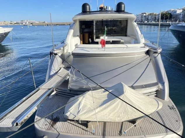 Luxury 2005 Pershing 76 yacht docked in a serene marina setting.