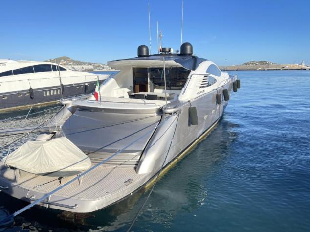 Luxury 2005 Pershing 76 yacht docked in a serene marina setting.