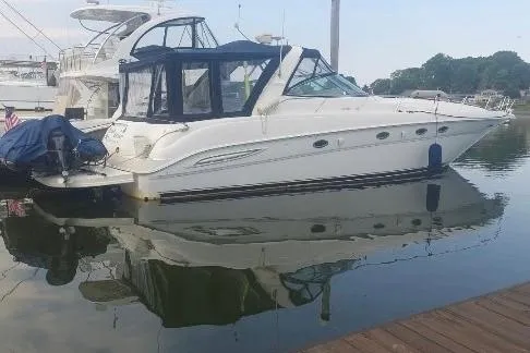 Irish Rover Yacht Photos Pics 2000 Sea Ray 460 Sundancer yacht docked in calm marina waters.