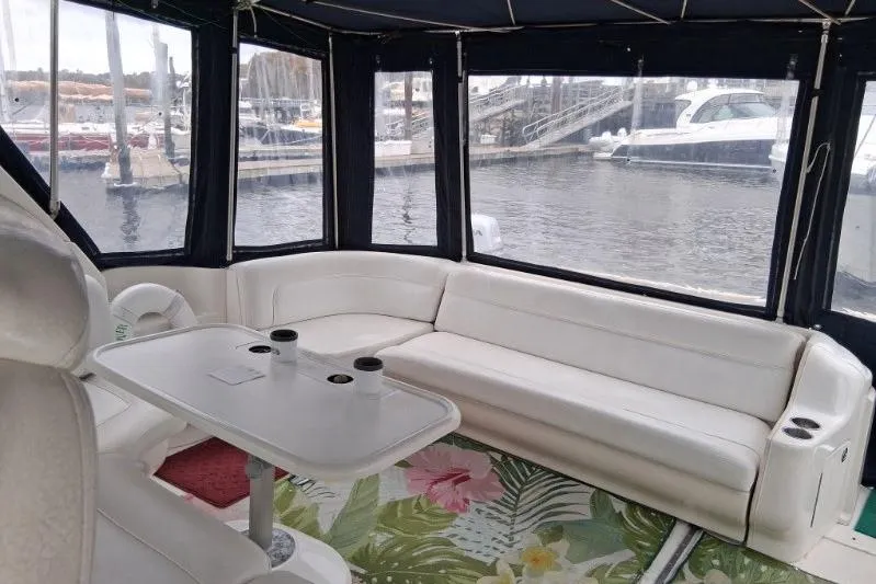 Irish Rover Yacht Photos Pics Interior of 2000 Sea Ray 460 Sundancer yacht with white seating and marina view.