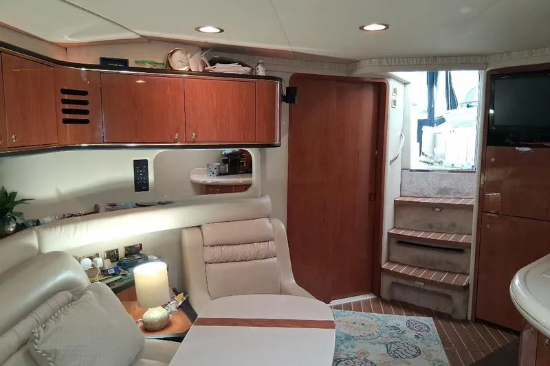 Irish Rover Yacht Photos Pics Interior of 2000 Sea Ray 460 Sundancer yacht with elegant wood cabinetry and cozy seating area.