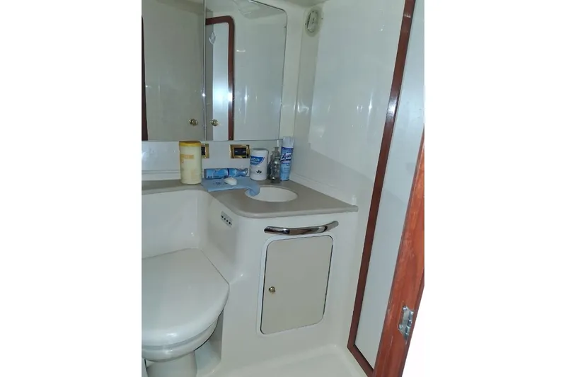 Irish Rover Yacht Photos Pics Bathroom interior of 2000 Sea Ray 460 Sundancer yacht, featuring sink and storage.