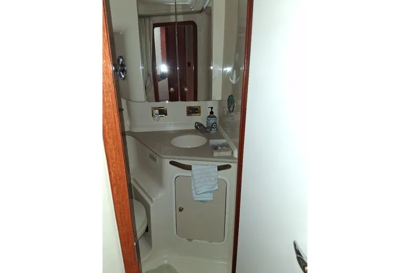 Irish Rover Yacht Photos Pics Bathroom interior of 2000 Sea Ray 460 Sundancer yacht, featuring sink and mirror.