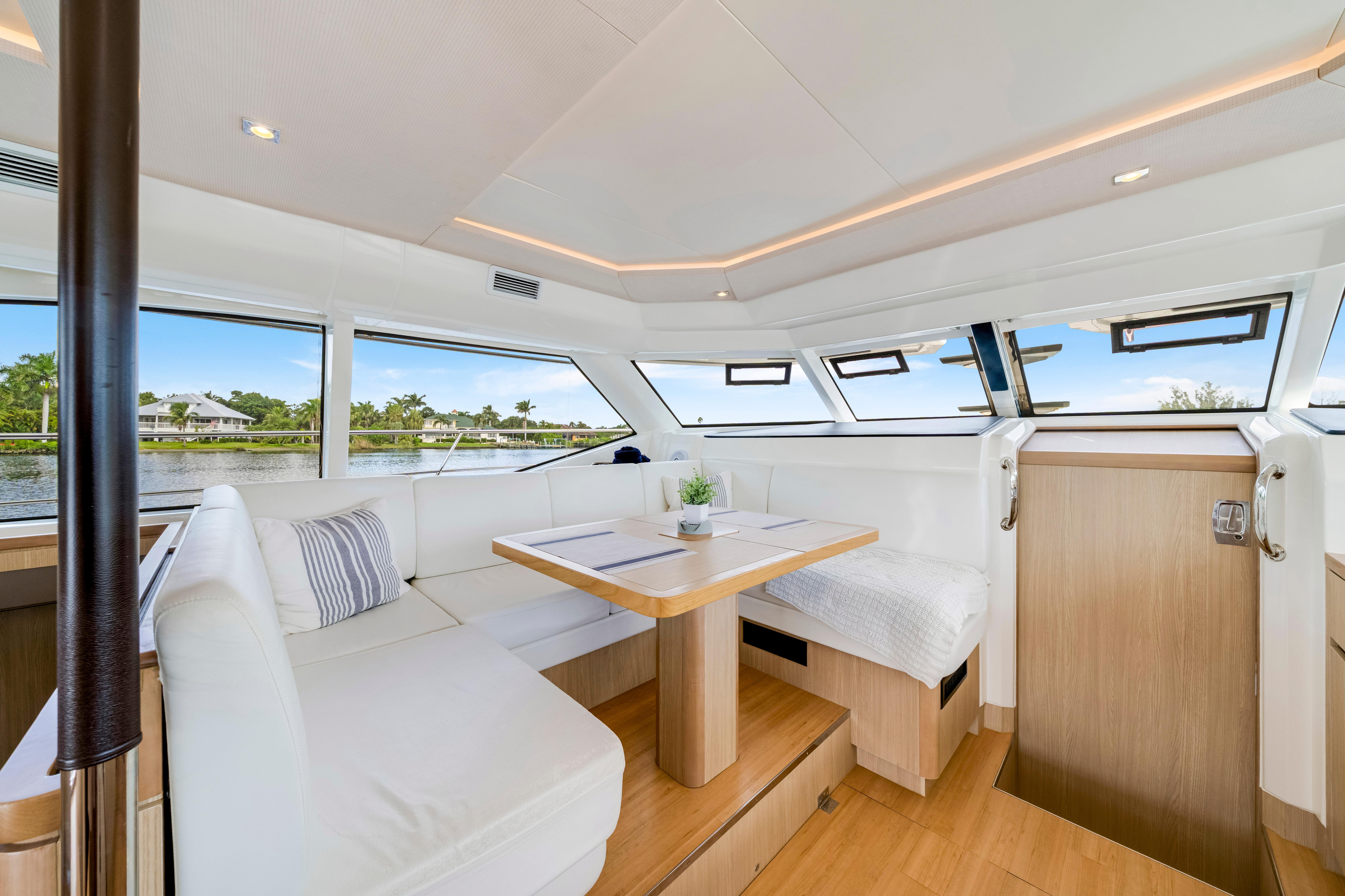 Luxurious interior of 2019 Aquila 44 Yacht with elegant seating and panoramic windows.