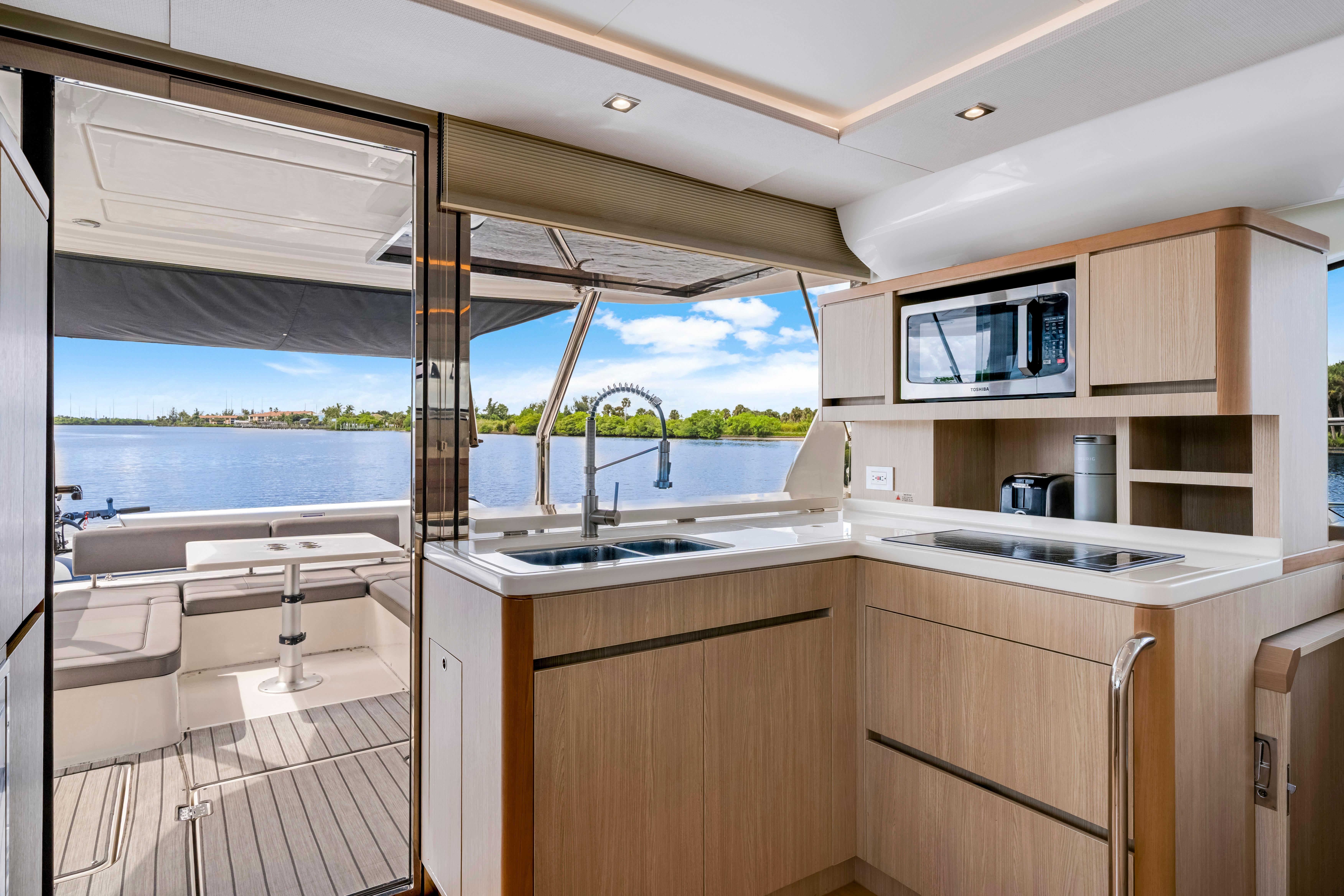 Modern kitchen interior of 2019 Aquila 44 Yacht with scenic water view.