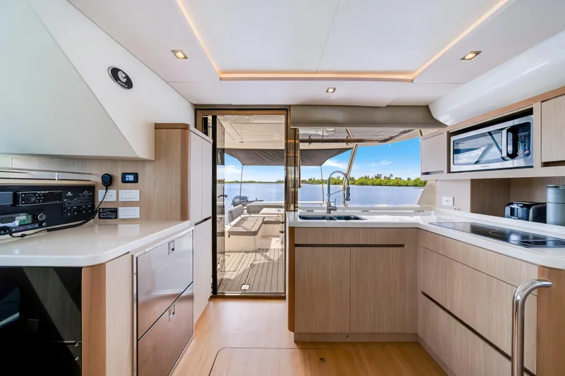 Altair Yacht Photos Pics Modern kitchen interior of 2019 Aquila 44 Yacht with scenic water view.