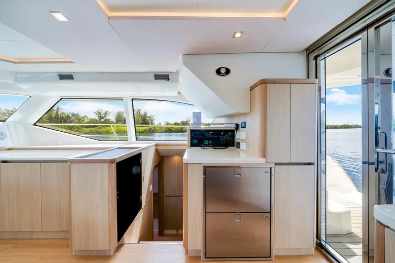 Altair Yacht Photos Pics Interior of 2019 Aquila 44 Yacht with modern kitchen and scenic water view.