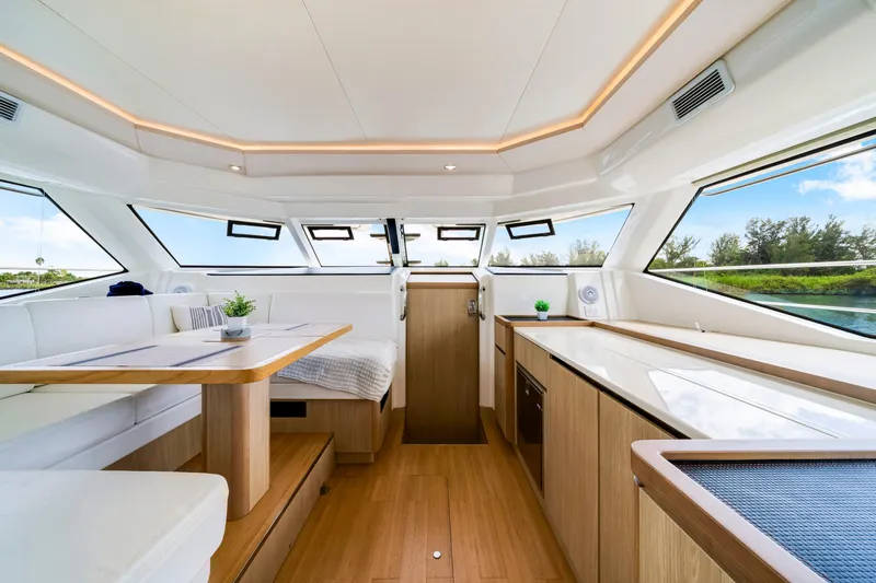 Altair Yacht Photos Pics Luxurious interior of 2019 Aquila 44 Yacht with modern furnishings and panoramic windows.
