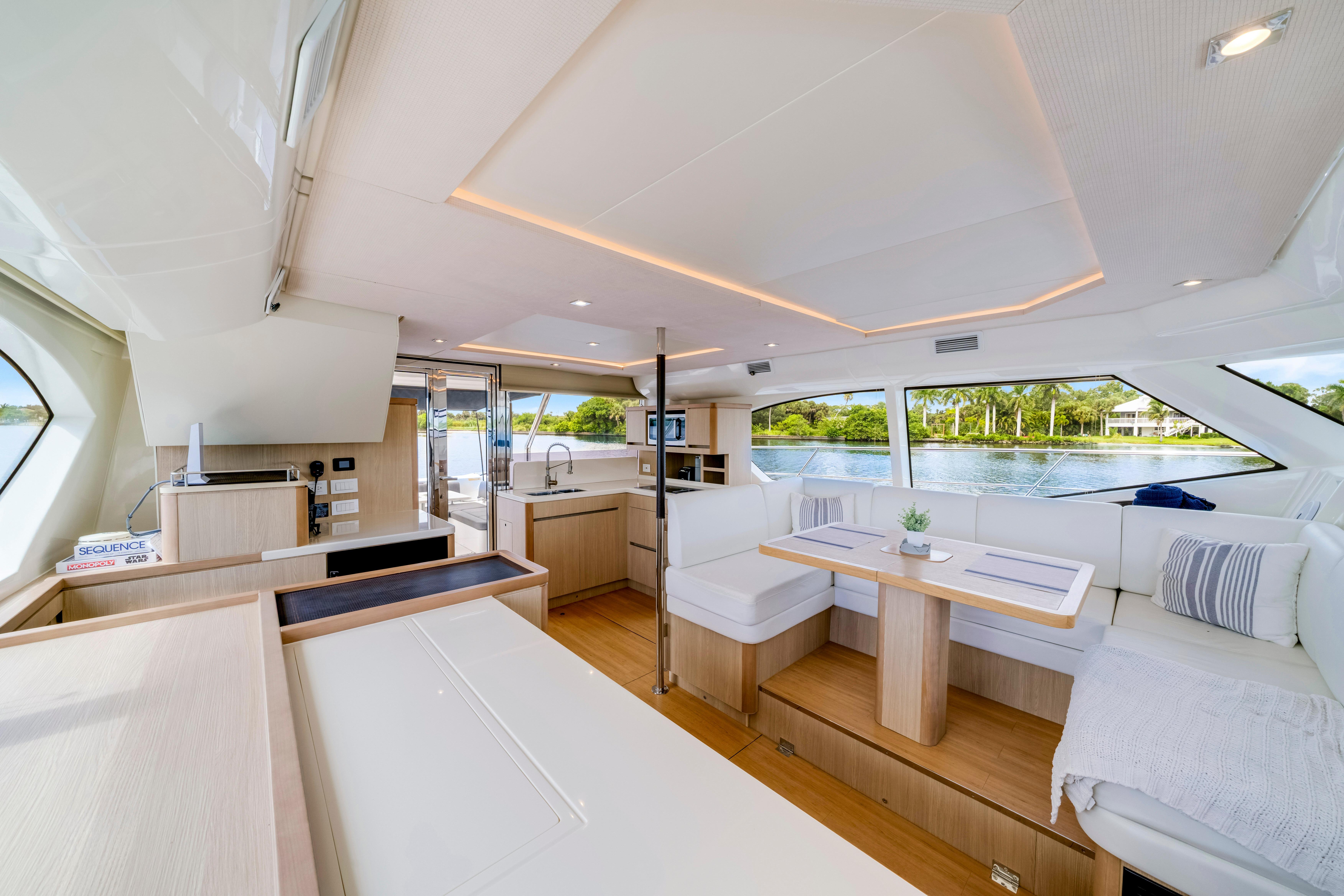 Luxurious interior of 2019 Aquila 44 Yacht with modern seating and panoramic windows.