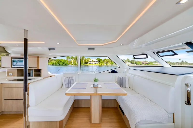 Altair Yacht Photos Pics Luxurious interior of 2019 Aquila 44 Yacht with elegant seating and scenic window views.
