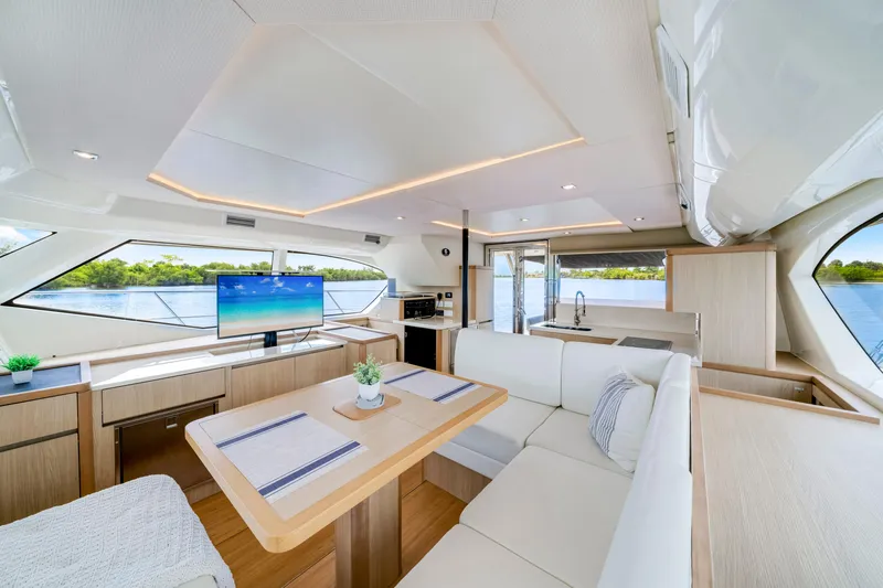 Altair Yacht Photos Pics Luxurious interior of 2019 Aquila 44 Yacht with modern furnishings and scenic water view.