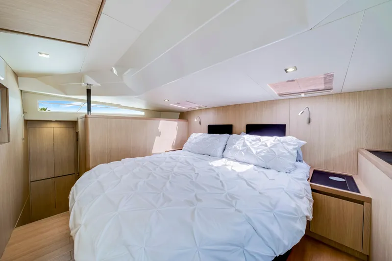 Altair Yacht Photos Pics Luxurious bedroom interior of 2019 Aquila 44 Yacht with modern design and cozy bedding.