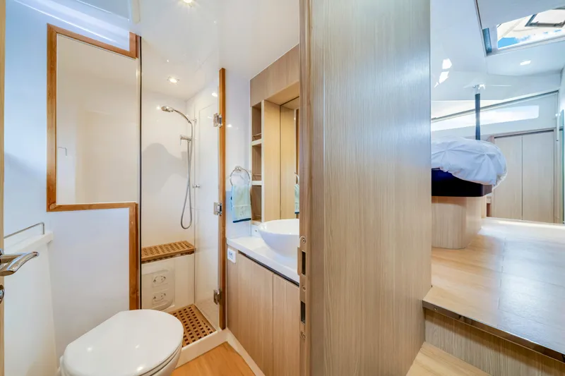 Altair Yacht Photos Pics Luxurious bathroom and bedroom interior of 2019 Aquila 44 Yacht, featuring modern design.
