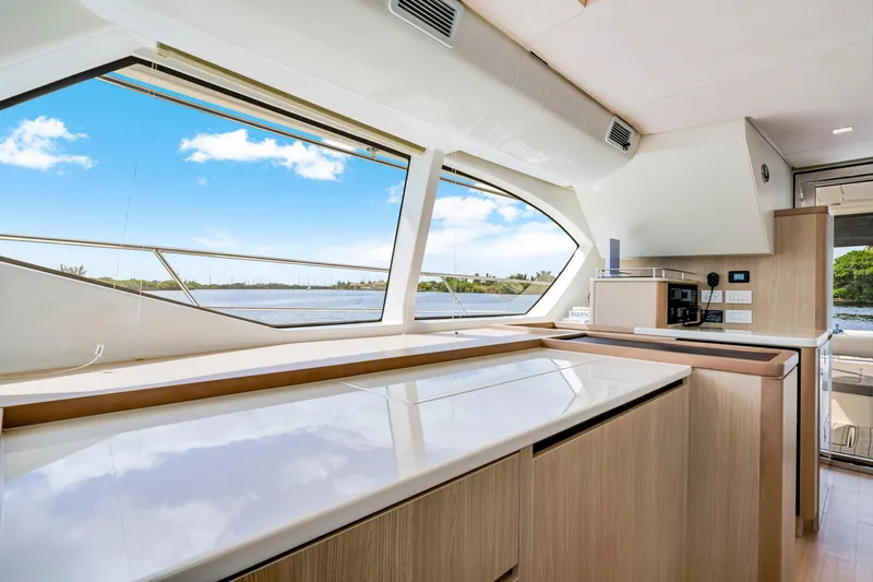 Altair Yacht Photos Pics Interior view of 2019 Aquila 44 Yacht kitchen with large windows and modern design.