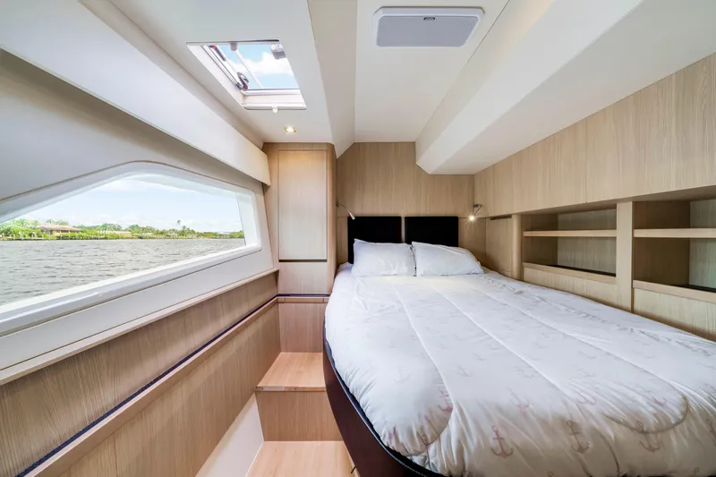 Altair Yacht Photos Pics Luxurious bedroom interior of 2019 Aquila 44 Yacht with scenic water view.