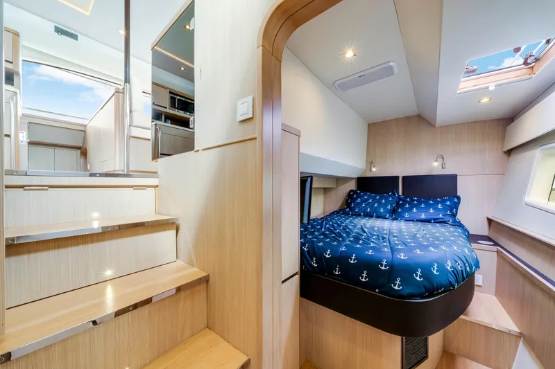 Altair Yacht Photos Pics Interior of 2019 Aquila 44 Yacht featuring cozy bedroom and modern wooden staircase.