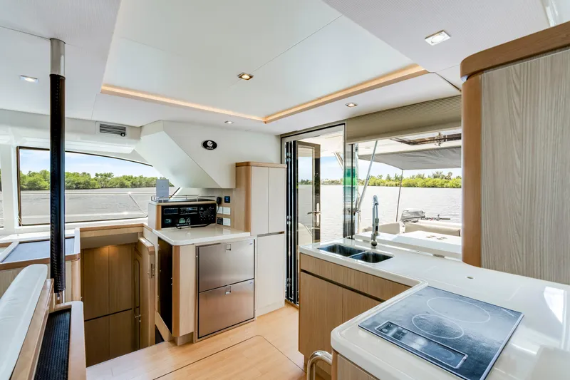 Altair Yacht Photos Pics Interior of 2019 Aquila 44 Yacht featuring modern kitchen and scenic water view.