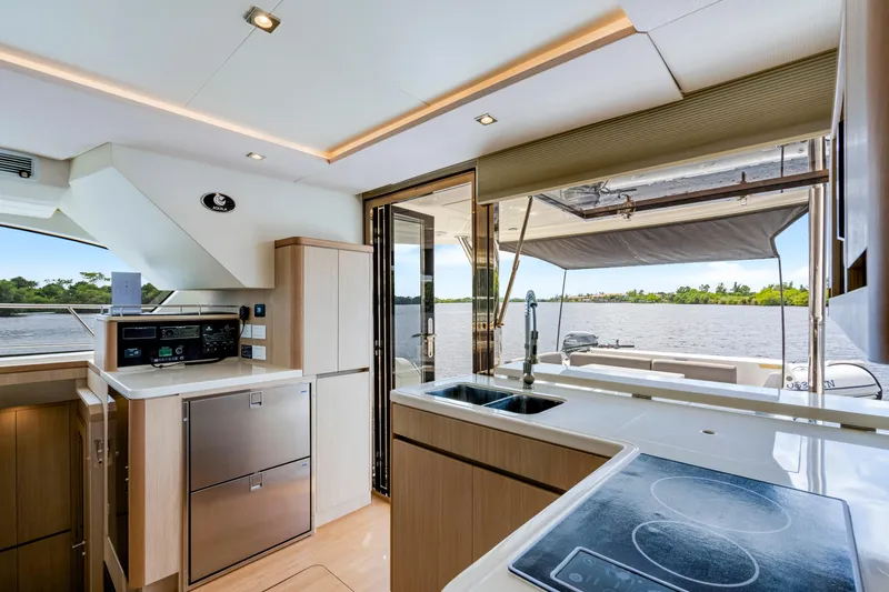 Altair Yacht Photos Pics Interior of 2019 Aquila 44 Yacht with modern kitchen and scenic water view.