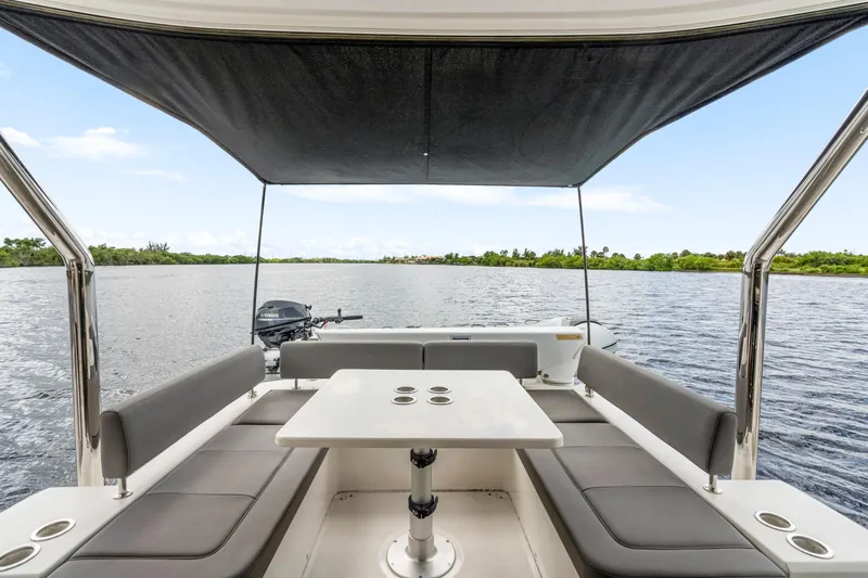 Altair Yacht Photos Pics 2019 Aquila 44 Yacht interior with seating and table, overlooking serene water view.