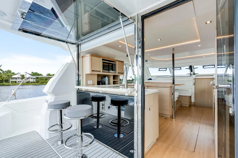 Altair Yacht Photos Pics Luxurious interior of 2019 Aquila 44 Yacht with modern kitchen and seating area.
