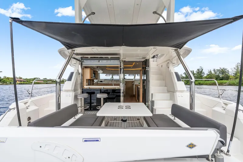 Altair Yacht Photos Pics 2019 Aquila 44 Yacht with shaded outdoor seating and interior view.