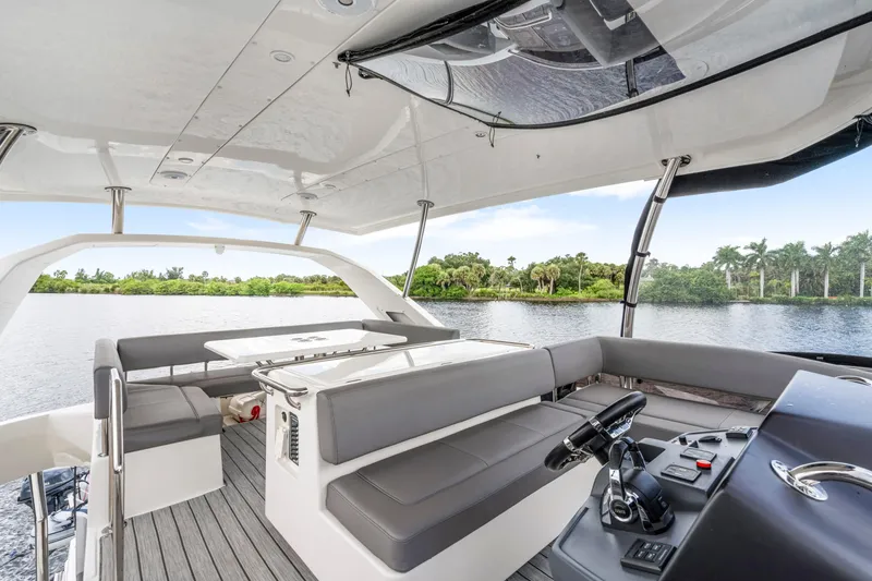 Altair Yacht Photos Pics Luxurious 2019 Aquila 44 Yacht interior with sleek seating and scenic water view.
