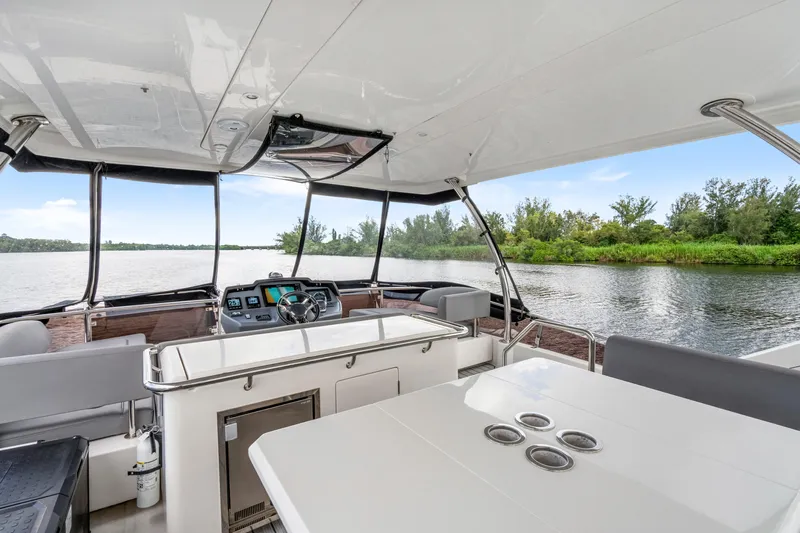 Altair Yacht Photos Pics 2019 Aquila 44 Yacht interior with helm, seating, and river view.