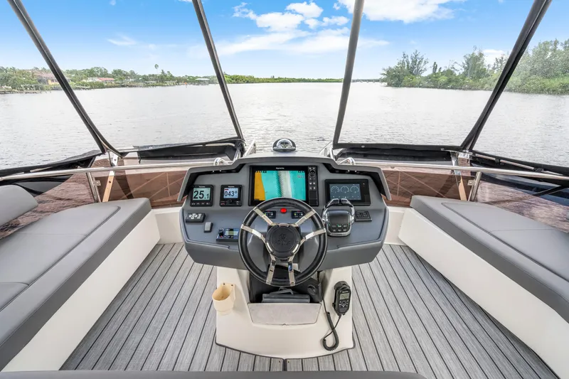Altair Yacht Photos Pics 2019 Aquila 44 Yacht helm with modern navigation system and panoramic water view.