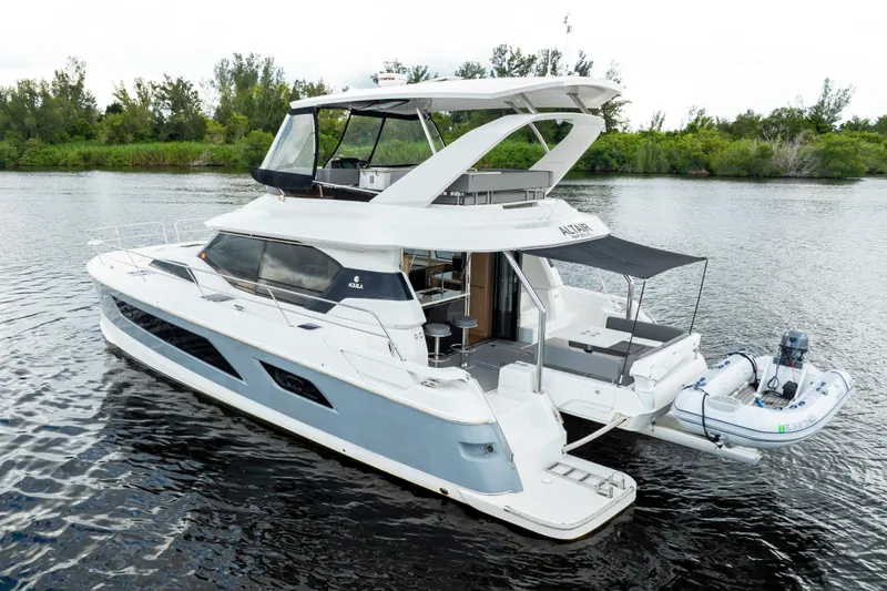 Altair Yacht Photos Pics 2019 Aquila 44 Yacht on calm water, featuring sleek design and spacious deck.