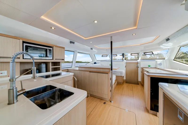 Altair Yacht Photos Pics Luxurious interior of 2019 Aquila 44 Yacht with modern kitchen and panoramic windows.