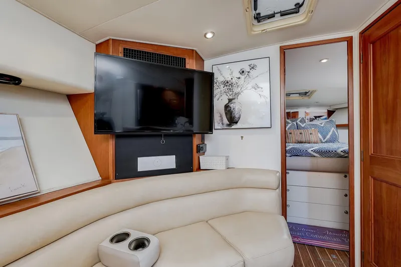 Archangel Yacht Photos Pics Interior of 1994 Viking 43 Open yacht with TV, artwork, and cozy seating area.