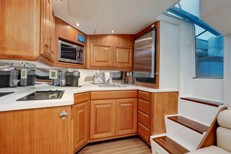 Archangel Yacht Photos Pics Luxurious 1994 Viking 43 Open yacht kitchen with wood cabinetry and modern appliances.