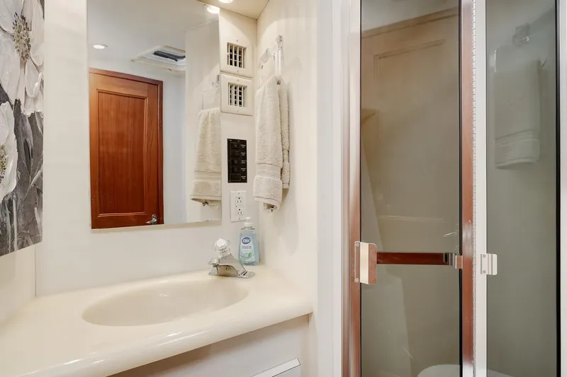 Archangel Yacht Photos Pics Bathroom interior of 1992 Viking 43 Open yacht with sink and shower.