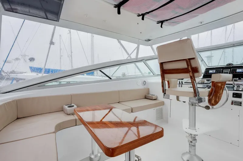 Archangel Yacht Photos Pics Interior of 1992 Viking 43 Open yacht with helm, seating, and wooden table.