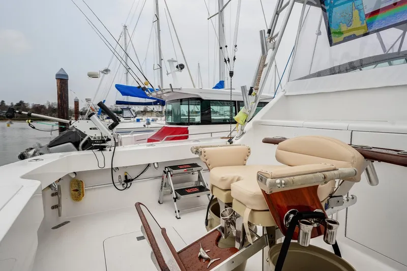Archangel Yacht Photos Pics 1992 Viking 43 Open yacht interior with fishing chair and equipment in marina setting.