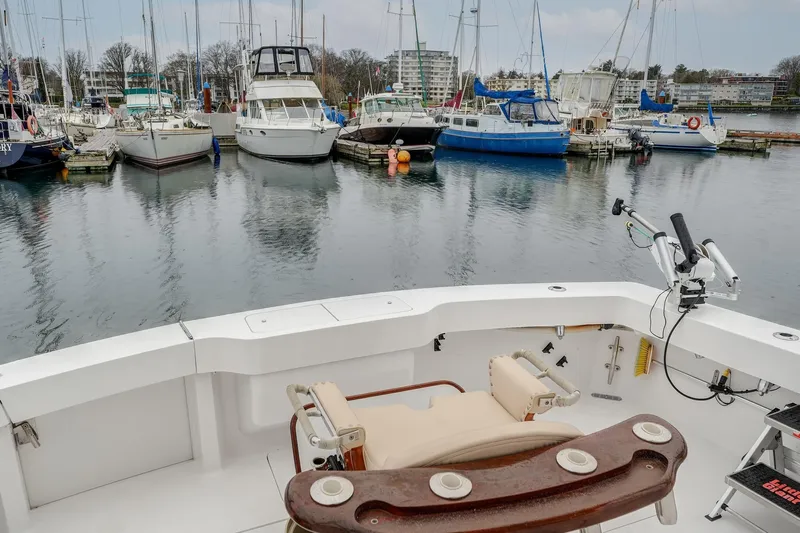 Archangel Yacht Photos Pics 1992 Viking 43 Open boat at marina with surrounding sailboats and calm water.