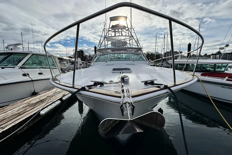 Archangel Yacht Photos Pics 1992 Viking 43 Open yacht docked at marina under cloudy sky.