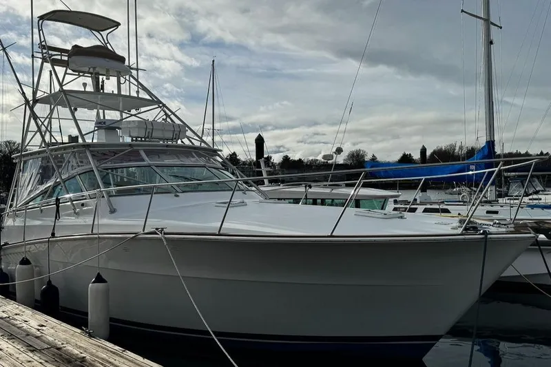 Archangel Yacht Photos Pics 1992 Viking 43 Open yacht docked at marina under cloudy sky.