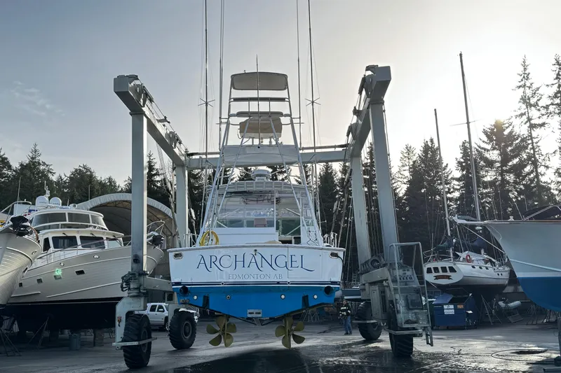 Archangel Yacht Photos Pics 1992 Viking 43 Open yacht "Archangel" in boatyard, lifted by crane, surrounded by trees.