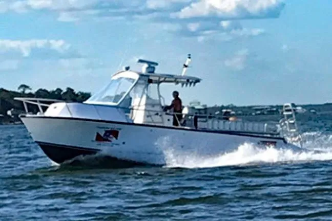  Yacht Photos Pics 2014 Newton 31 Dive Special boat cruising on open water under a partly cloudy sky.