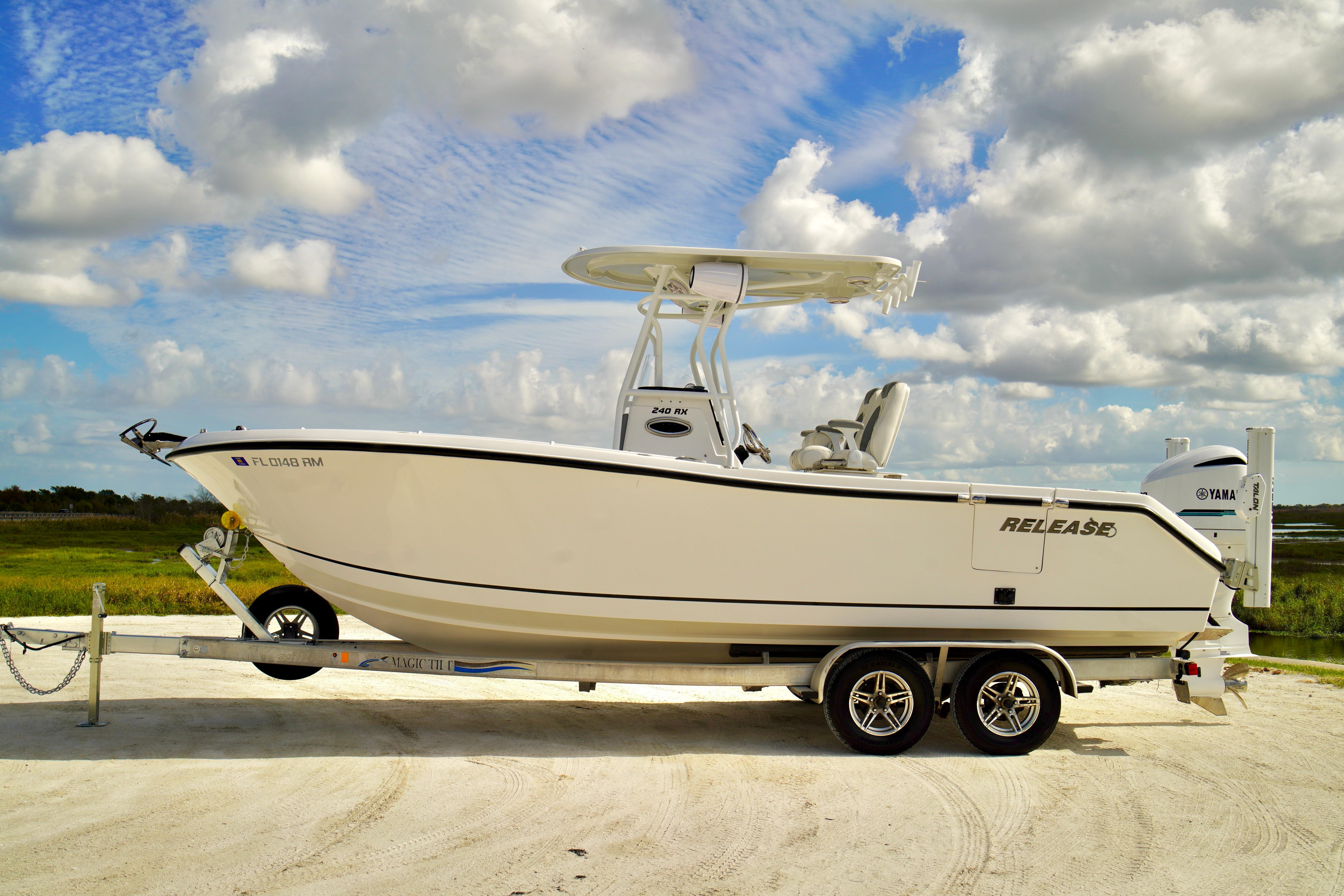 2017 Release 240 RX boat on trailer under cloudy sky.